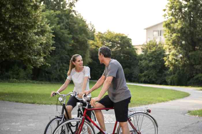 Young couple talking on their bikes
