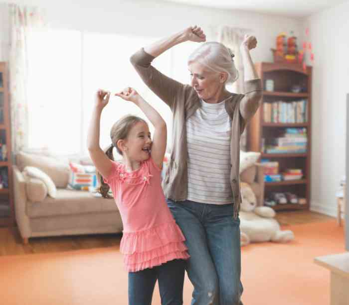 A Grandma wearing discreet hearing aids and her nephew dancing together