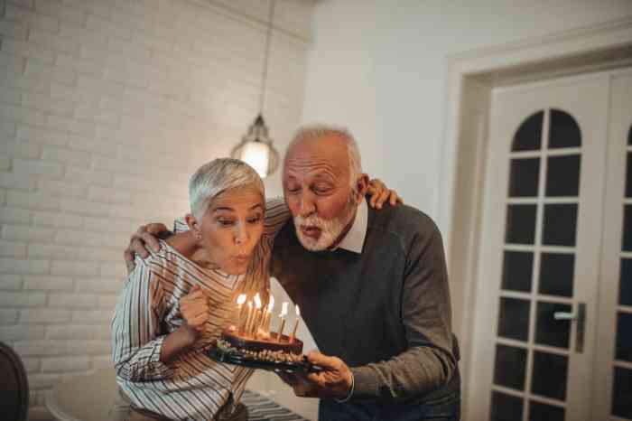 Senior couple celebrating birthday with a cake