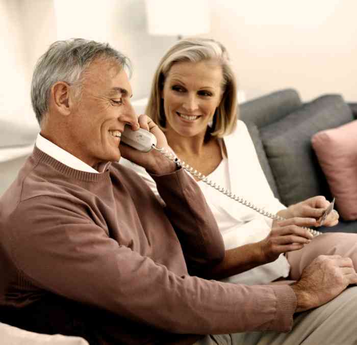 A senior couple using hearing impaired phone