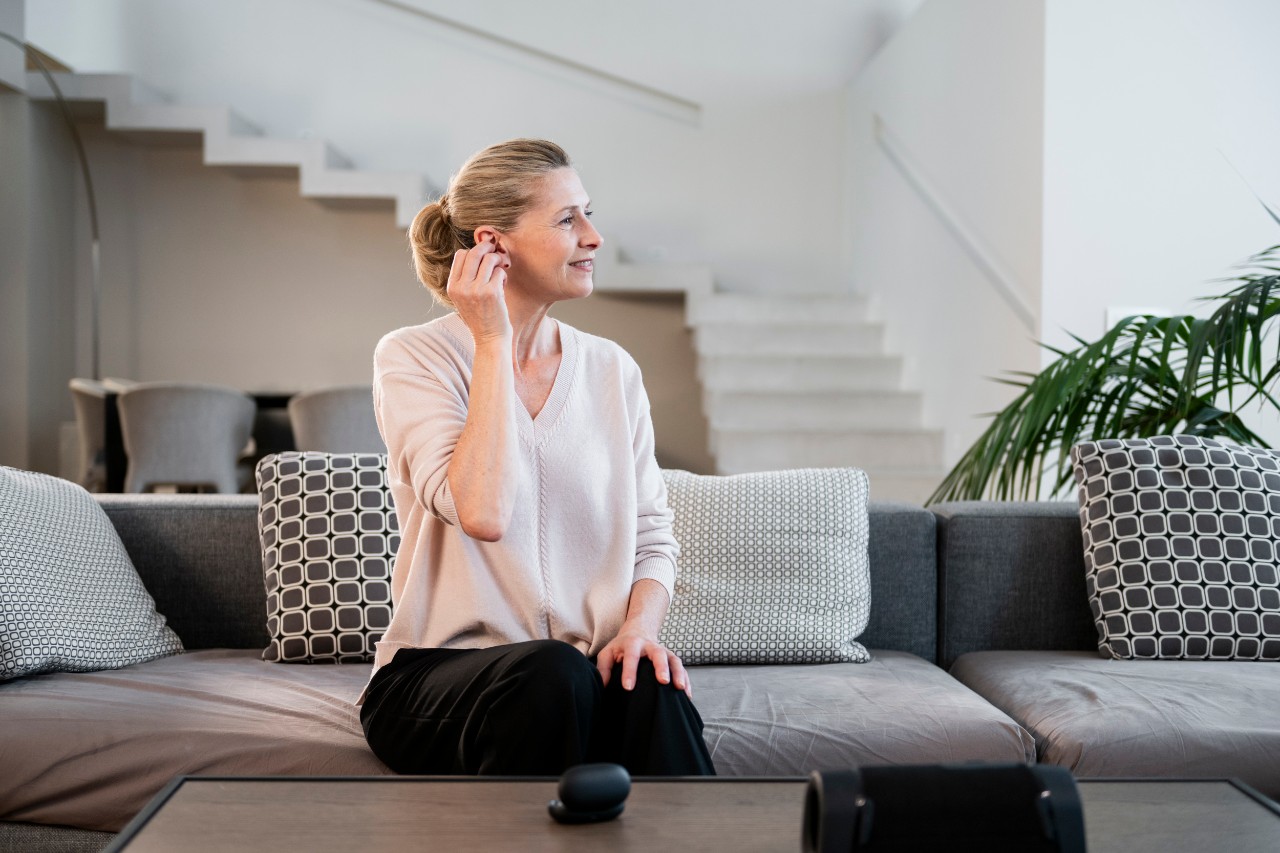 woman sitting on the sofa with hearing aids