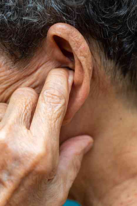 A man has his fingers in his ears.