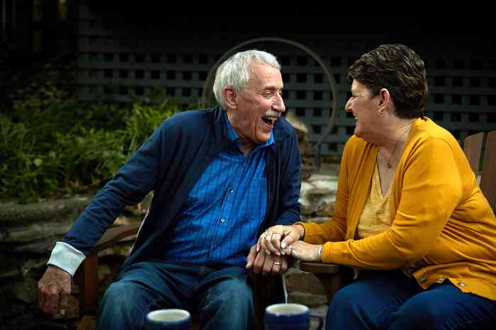Couple smiling while sitting outside