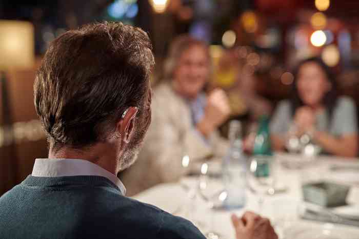 Man with hearing aids at dinner