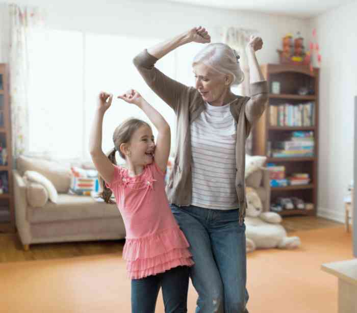 Grandmother and granddaughter dancing