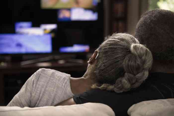 Couple on couch watching TV