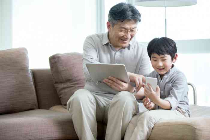 Grandfather and grandson on tablets