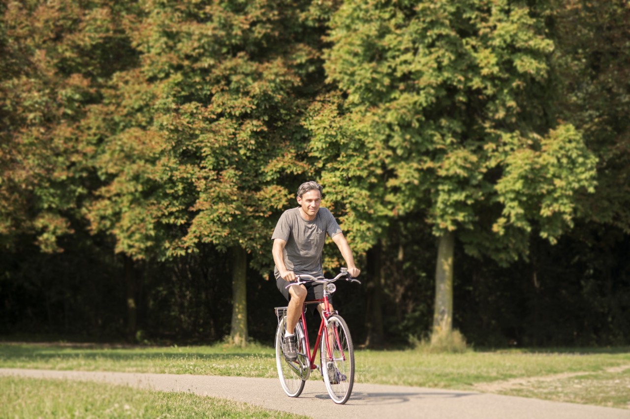 Homme fait du vélo dans un parc