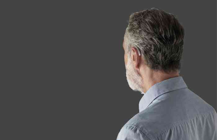 Profile of a man wearing Receiver-In-The-Canal hearing aids