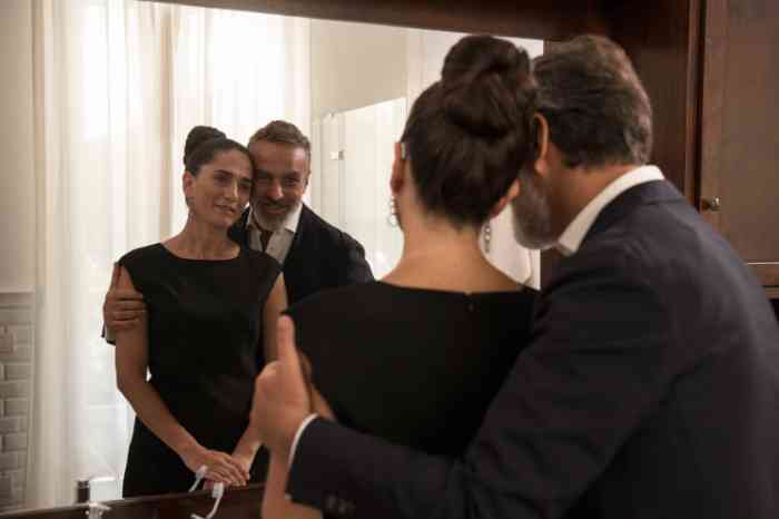 A couple with Behind-The-Ear hearing aid looking at the mirror