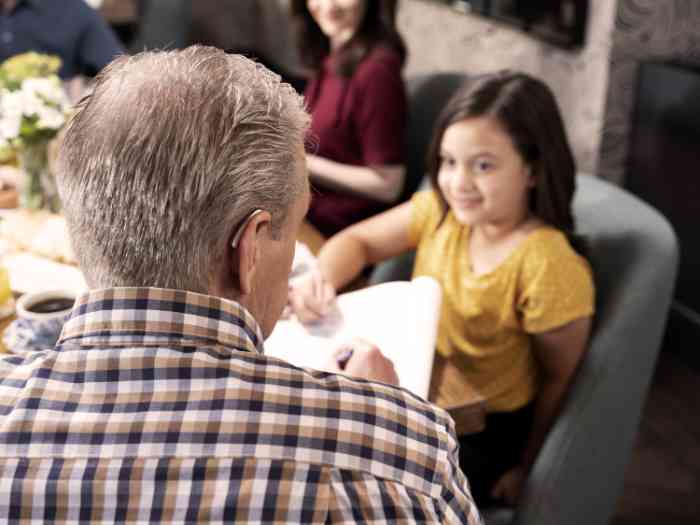 Nahaufnahme eines Familienmittagessens mit Großvater und Nichte.
