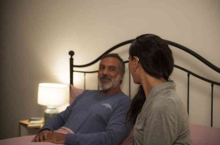 Couple in the bedroom with woman with Behind-The-Ear Hearing Aid