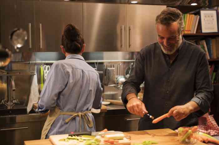 A man kisses his wife who's wearing a BTE hearing aid