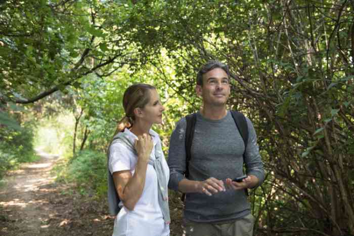 A couple walking between woods enjoying nature