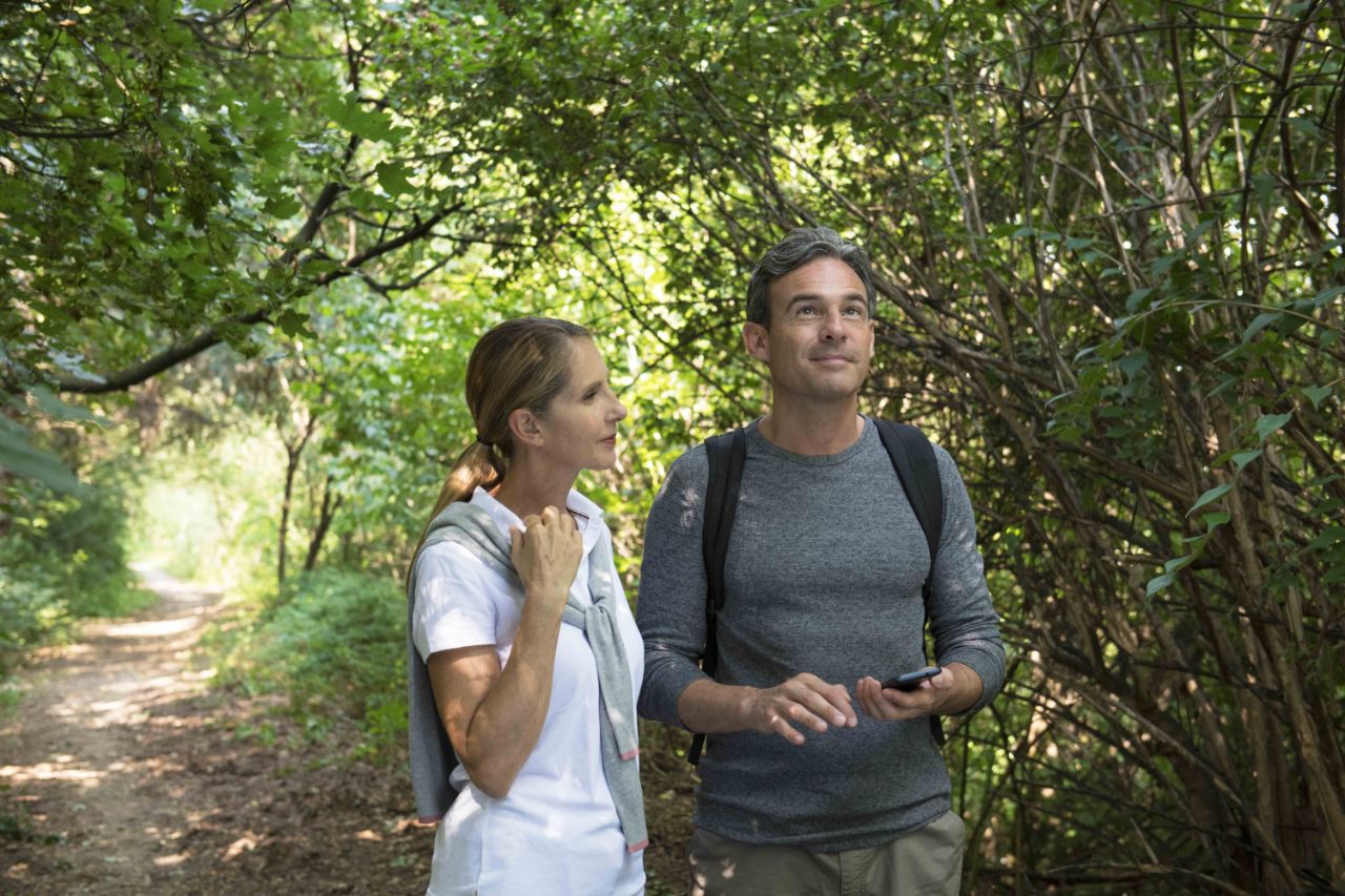 couple walking together in the woods.