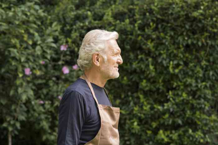 A man is cleaning his hearing aid