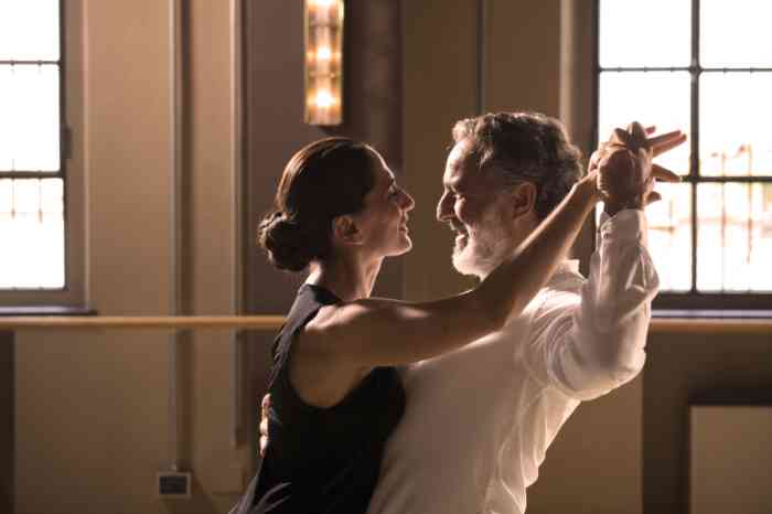 A woman wearing hearing aids dancing tango with her partner