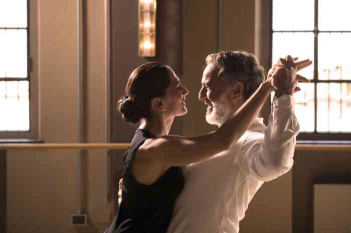 A woman wearing hearing aids dancing tango with her partner