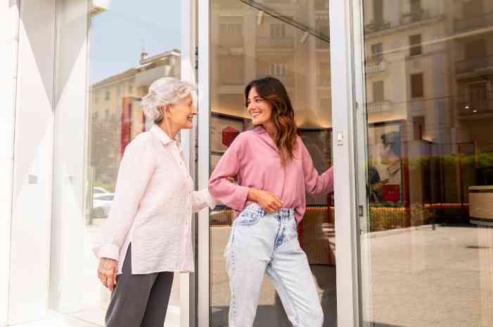 A mother and daughter entering an Amplifon store