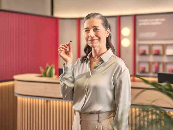 client holding a mini titanium product.