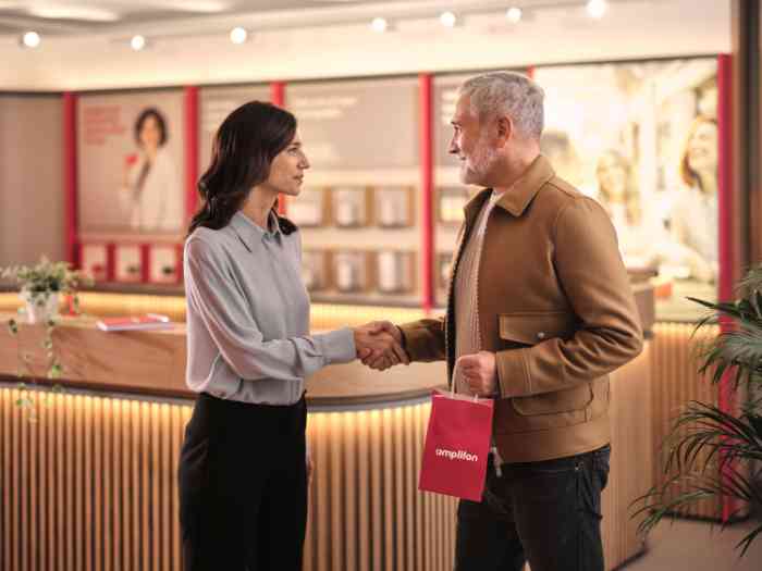 An audiologist shaking hands with a patient