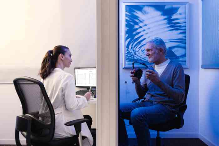 Amplifon audiologist and senior man during a free hearing test