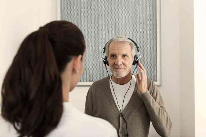 A senior man wearing headphones