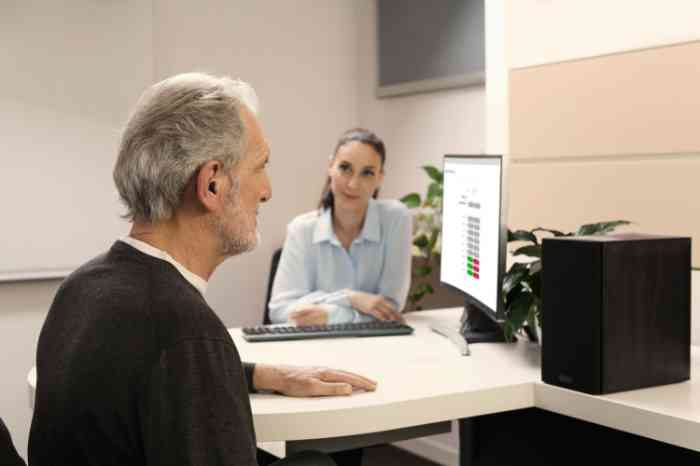 A man is taking a hearing test with an audiologist