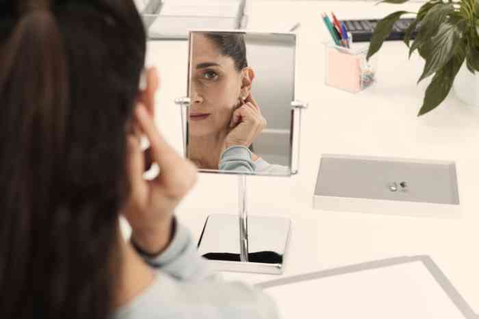 A woman fitting her BTE hearing aid