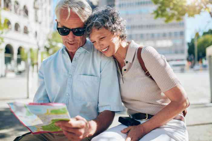 A senior couple of tourist looking at a map