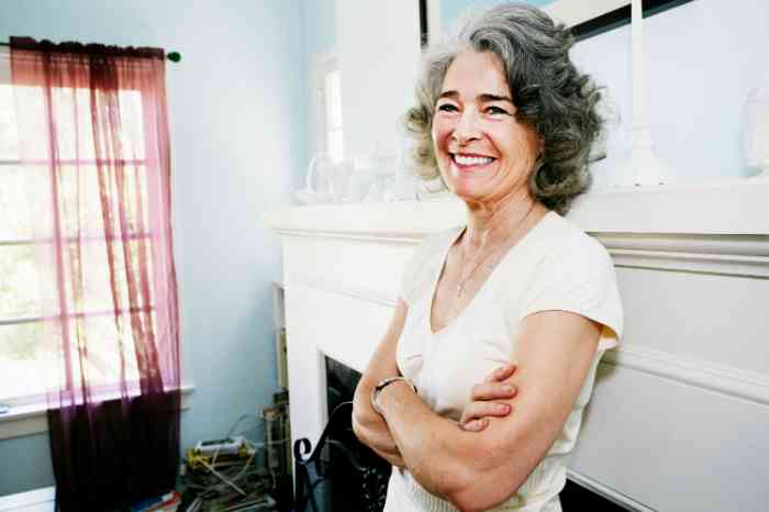 A senior woman smiling in her house