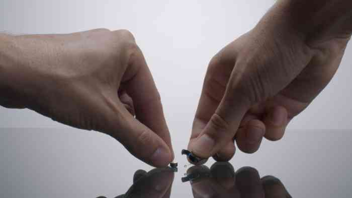 A man changing batteries to hearing aids