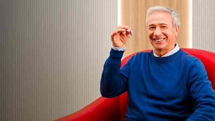 Man showing a hearing aid