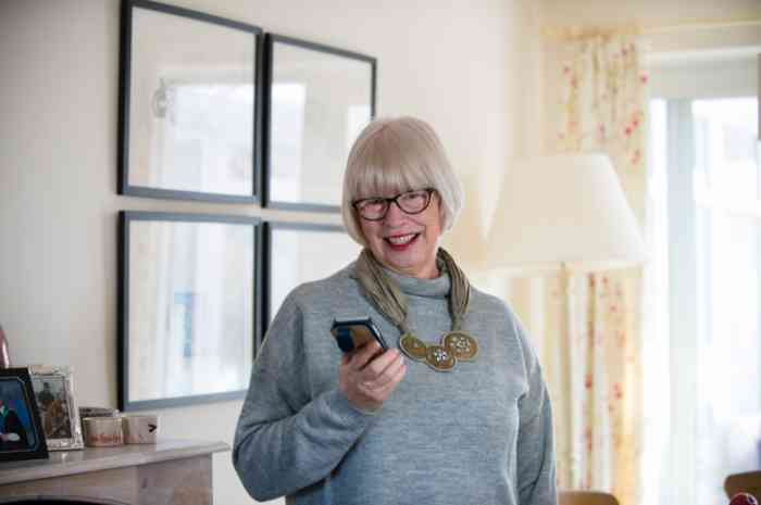 A man is cleaning his hearing aid
