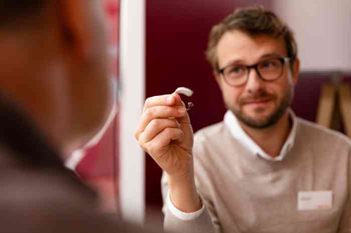 A man is cleaning his hearing aid