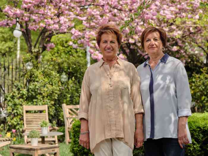 zwei Frauen mit blühenden Bäumen im Hintergrund